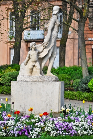 A stone statue of woman holding her childの写真素材