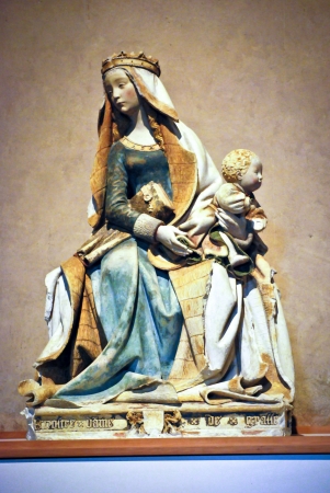 Colored stone statue of the virgin Mary carrying a childのeditorial素材