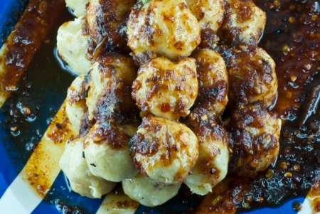 Stack of meatball with spicy sauceの写真素材