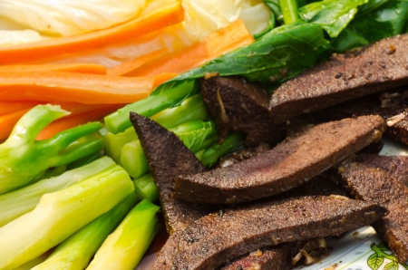 Grilled pork liver with boilled carrot and vegetableの写真素材