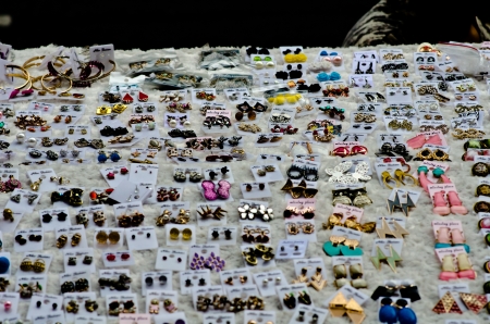 Many colorful handmade earrings for sale at outside street market fair の写真素材