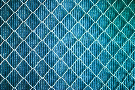 iron wire fence on green backgroundの写真素材
