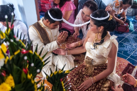 Asian thai couple bride and bridegroom in thai wedding suit at wedding ceremonyのeditorial素材