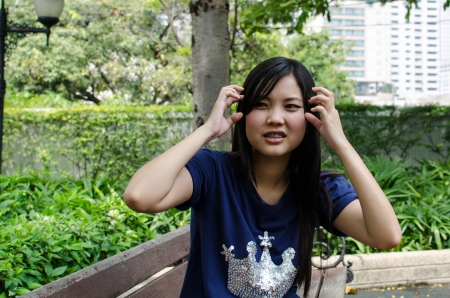 Lovely Chinese girl feels annoyed in the gradenの写真素材