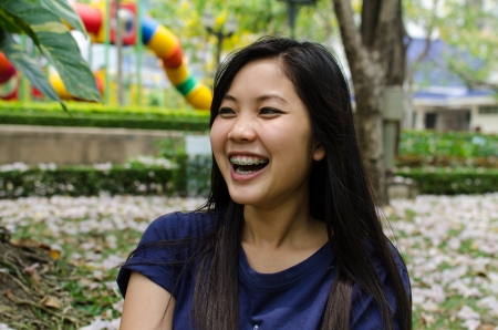 Lovely Chinese girl tell a story in the gradenの写真素材