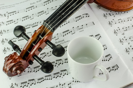 Closeup od violin and coffee cup on music sheet の写真素材