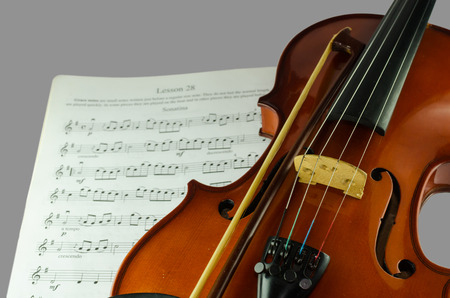 Closeup photo of violin and bow on note sheet with text spaceの写真素材