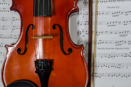 Closeup photo of violin on note sheet の写真素材