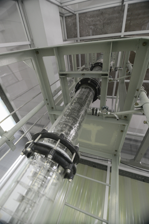 Wide angle view of extraction column in laboratory with ladder and metal plating around itの写真素材