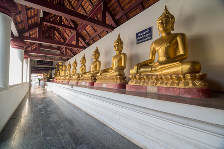 Golden Buddha statue in the cloisterの写真素材