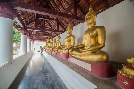 Golden Buddha statue in the cloisterの写真素材
