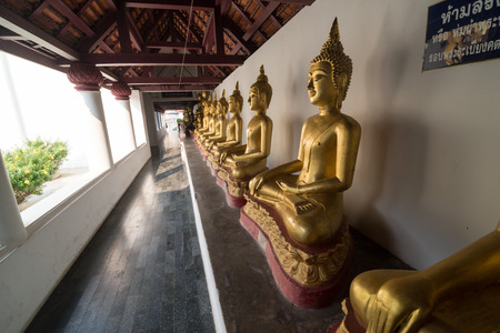 Golden Buddha statue in the cloisterの写真素材