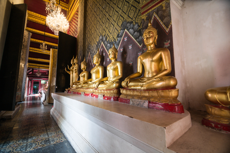 Golden Buddha statue in the cloisterの写真素材
