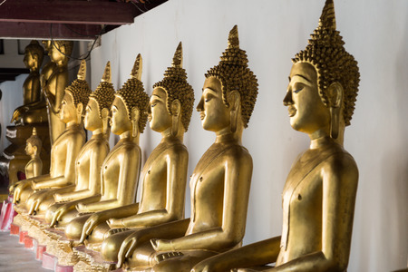 Golden Buddha statue in the cloisterの写真素材