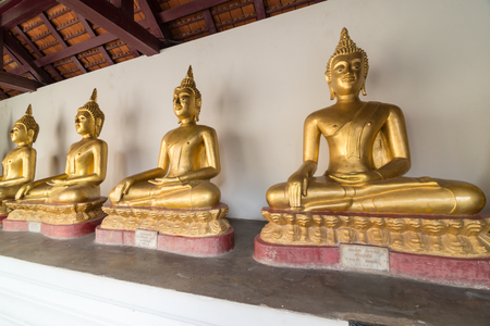 Golden Buddha statue in the cloisterの写真素材