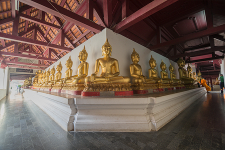 Golden Buddha statue in the cloisterの写真素材