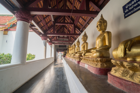 Golden Buddha statue in the cloisterの写真素材