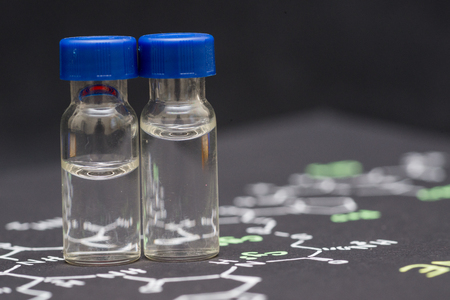 Close-up blue cap sample vial on paper with chemical formula of Oxytocin (love hormone)の写真素材