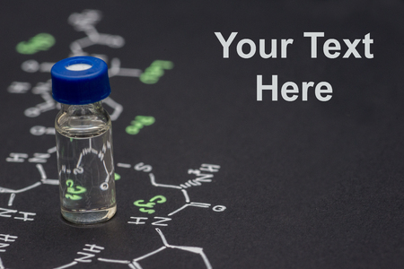 Close-up blue cap sample vial on paper with chemical formula of Oxytocin (love hormone) with text spaceの写真素材