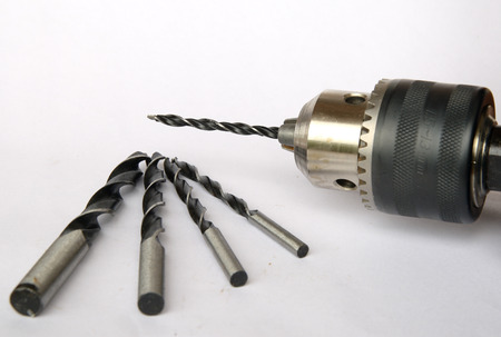 drill and drill bit on white backgroundの写真素材