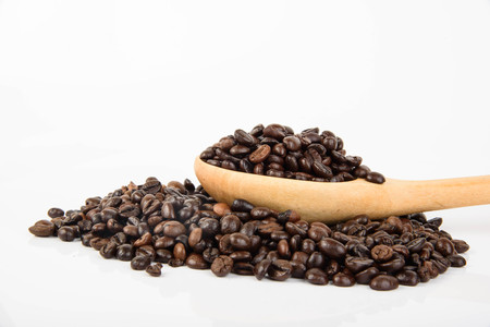 Coffee beans on wooden spoon isolated on white background (coffee)の写真素材