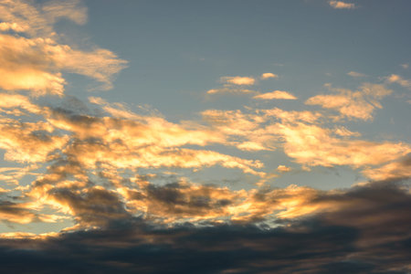 Cumulus before sunset clouds with sun setting down