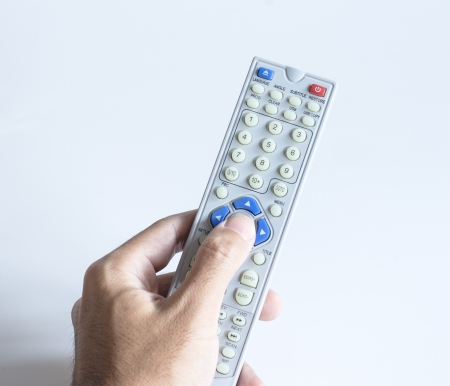 Hand using a remote control on white backgroundの写真素材