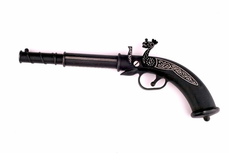 General view of an old pistol in black on a white backgroundの写真素材