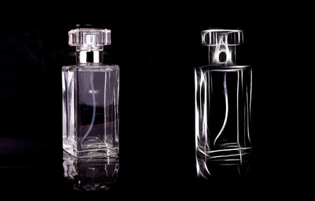 Transparent perfume bottle cosmetic liquid on a black backgroundの写真素材