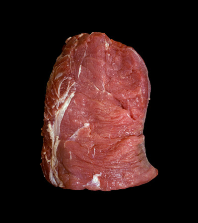 A general view of a piece of fresh raw beef meat on a black backgroundの写真素材