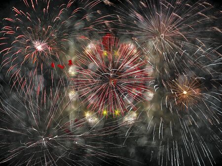 Festive lights - multicolored fireworks on a dark gray backgroundの写真素材