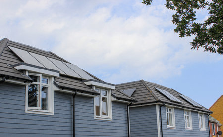 Solar panels installed on the house roof with blue sky