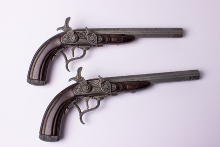Two old flintlock pistol on white backgroundの写真素材