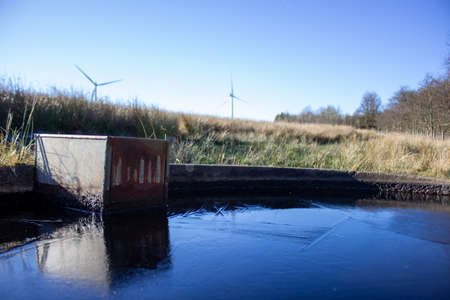 Close up of a windmills reflected in a water troughの写真素材