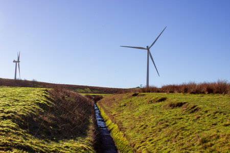 Wind farm in summer with blue clear sky background