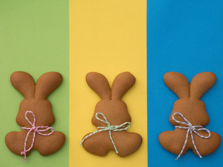 Easter cookies on colorful background. Easter baking. Making gingerbread easter cookies. Easter concept.の写真素材