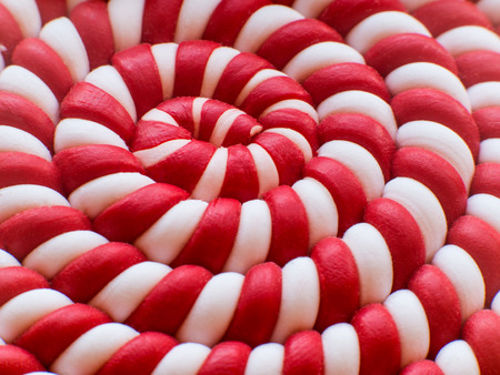 Closeup of white and red spiral lollipop background. Spiral background.の写真素材