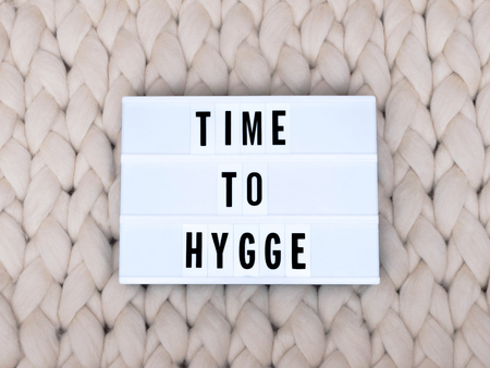TIME TO HYGGE word on lightbox on knit background. Cozy compozition. Knit background.の写真素材