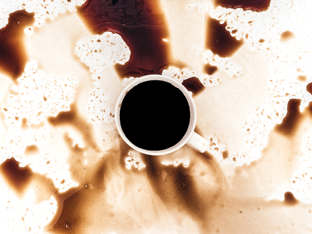 Cup of coffee spilled on white background, top view. For grunge advertisement design, copy spaceの写真素材