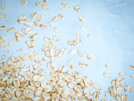 Oat milk drink in white cup and cereal flakes on kitchen bench. Flat lay. Copy space.の写真素材