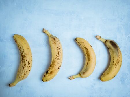 Old banana on light blue background. Zero waste concept. Save the lone bananaの写真素材