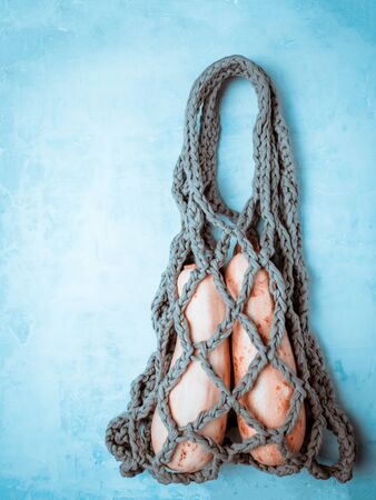 Cotton bag from t-shirt yarn on light blue background.の写真素材