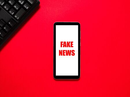 Text FAKE NEWS on red background.の写真素材