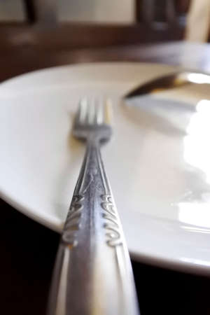 tableware on the table, consisting of a plate, fork and spoonの写真素材