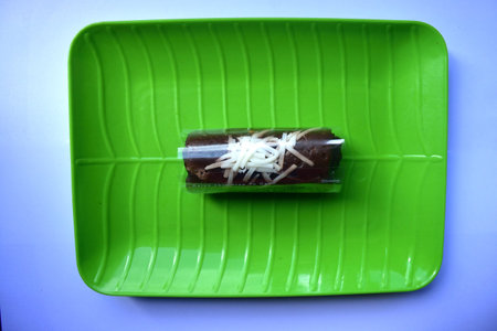Traditional snack of Indonesia, Chocolate rolled pancake with banana fillingの写真素材