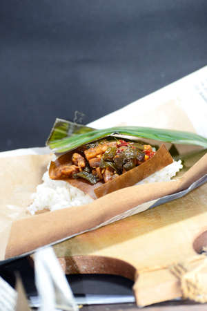Traditional food culinary from Indonesia, Nasi kucing consists of a small, fist-sized portion of rice along with toppings. Food wrap from old newspapersの写真素材