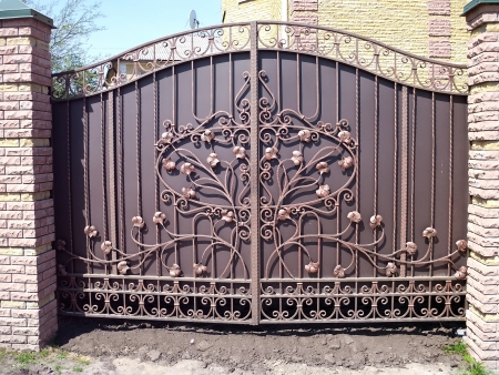 Beautiful bronze-colored metal gate with forged elements の写真素材