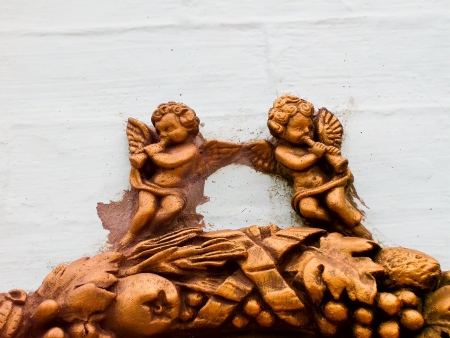 Figures of two golden angels on the building の写真素材