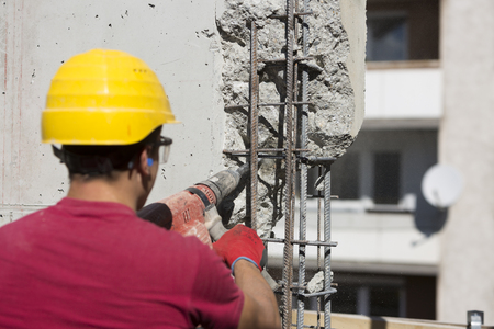 Construction worker using a drilling power toolの写真素材