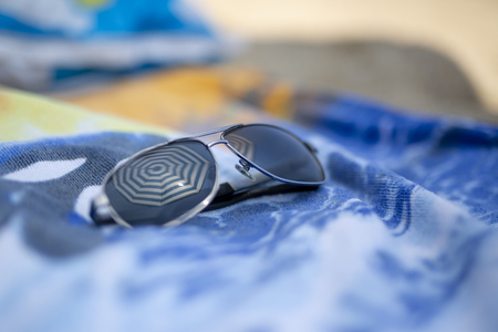 Reflecting sunglasses on the beachの写真素材